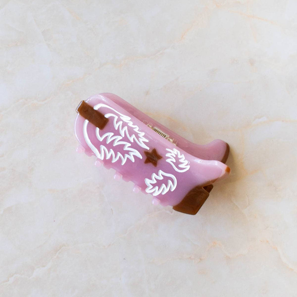 Western Boot Hair Claw Clip, the perfect accessory for any Western-inspired outfit. Made with sustainable materials, this clip showcases an intricate boot design and features a secure, easy-to-use grip. Upgrade your hair game with this eco-friendly and stylish clip.