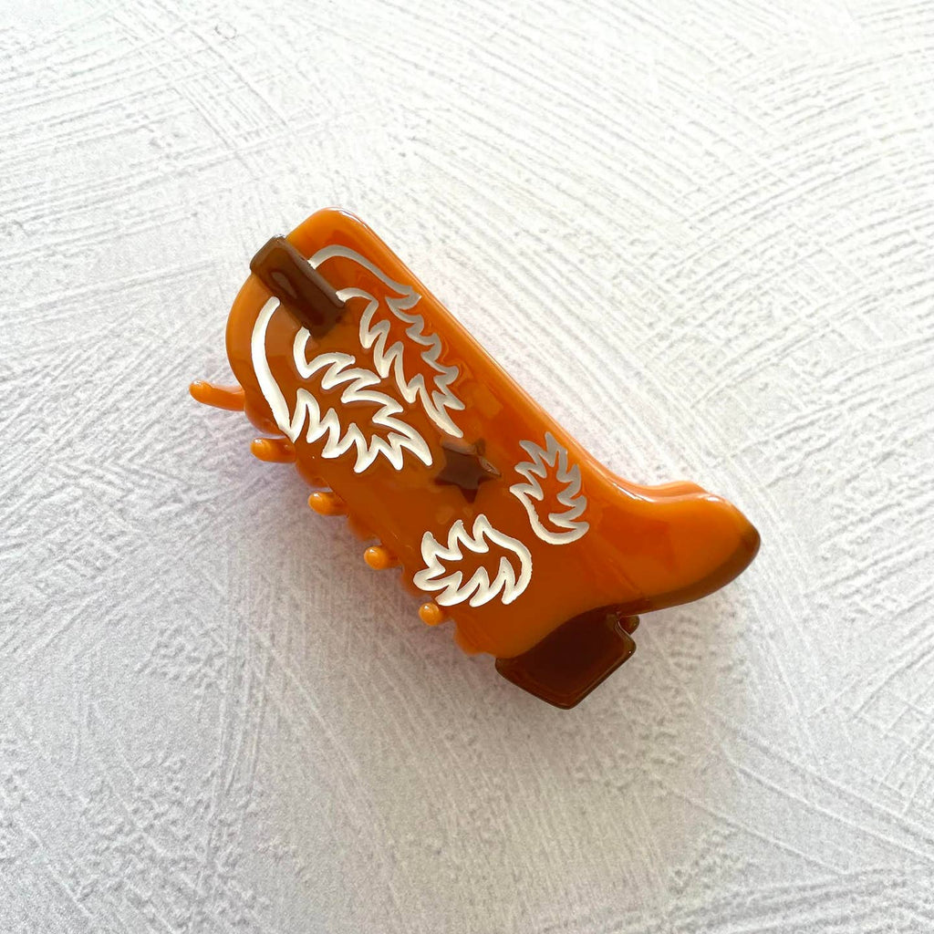 Western Boot Hair Claw Clip, the perfect accessory for any Western-inspired outfit. Made with sustainable materials, this clip showcases an intricate boot design and features a secure, easy-to-use grip. Upgrade your hair game with this eco-friendly and stylish clip.