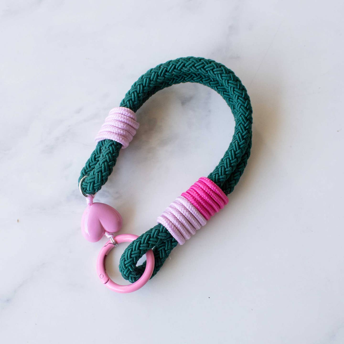 This versatile rope keychain features a charming heart charm and can also be used as a stylish bag accessory. The durable design is perfect for holding all of your keys securely, while adding an elegant touch to your everyday essentials. Keep your belongings organized and fashionable with this must-have accessory.