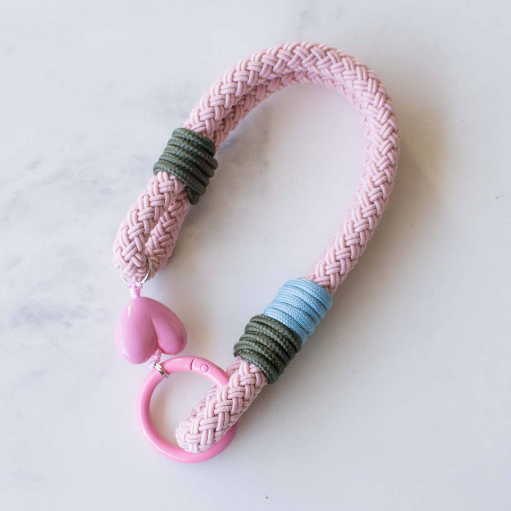 This versatile rope keychain features a charming heart charm and can also be used as a stylish bag accessory. The durable design is perfect for holding all of your keys securely, while adding an elegant touch to your everyday essentials. Keep your belongings organized and fashionable with this must-have accessory.