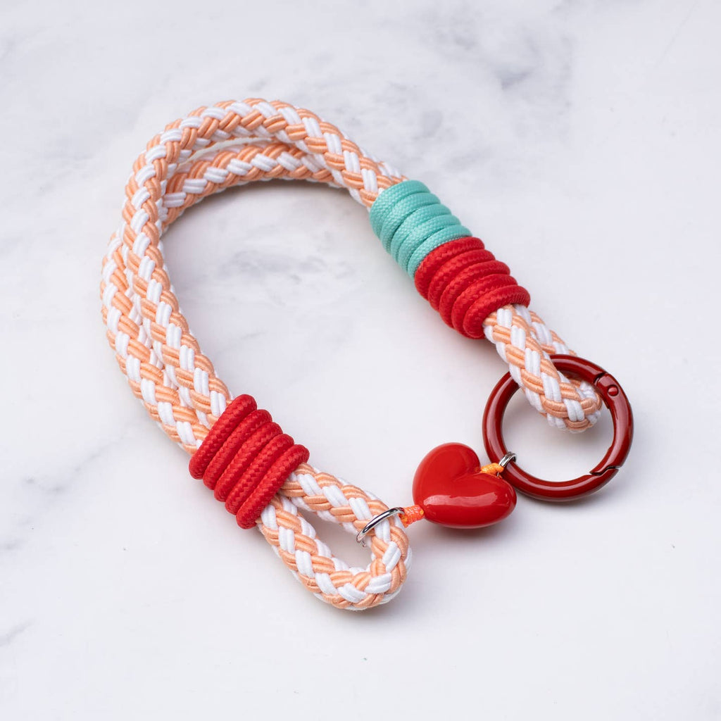This versatile rope keychain features a charming heart charm and can also be used as a stylish bag accessory. The durable design is perfect for holding all of your keys securely, while adding an elegant touch to your everyday essentials. Keep your belongings organized and fashionable with this must-have accessory.