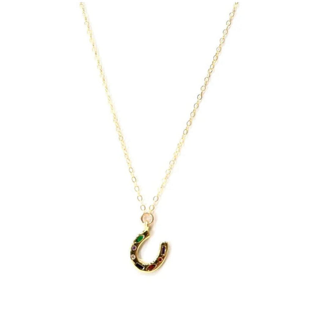 Head west with this lucky horseshoe covered in stunning colored cz's. Horseshoes are said to symbolize protection and give good luck to those who posses them. Use this piece for layering or gracefully on it's own.

Strung on 14k Goldfill chain, it won't tarnish or change colors, even with daily wear. This necklace is 16" length with 2" extender. The pendant itself is gold plated with an extra layer of tarnish resistance.