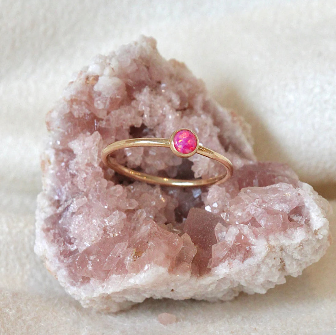 This ring is hand-formed in either sterling silver or 14k goldfill and set with a cultured Cherry Pink opal.&nbsp; Perfect for mixing into a stack or standing out on it's own!