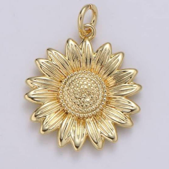 Add a little sunshine to your outfit with our Gold Sunflower Charm. Featuring a beautiful sunflower design, this necklace or bracelet charm adds a touch of elegance and warmth to any look. The gold color adds a hint of luxury, making it the perfect addition to your jewelry collection.