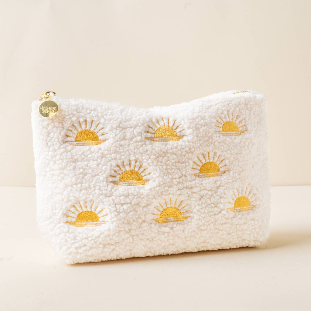 Add a cozy touch to your essentials with our rectangle teddy pouches. Crafted from soft sherpa fabric, these pouches feature a wipeable lining for easy cleaning and gold zippers and hardware for a polished look. The interior is lined with a fun printed fabric, making it as stylish on the inside as it is on the outside. The large rectangle size is perfect for keeping your items organized, and it pairs beautifully with our square or circle options.