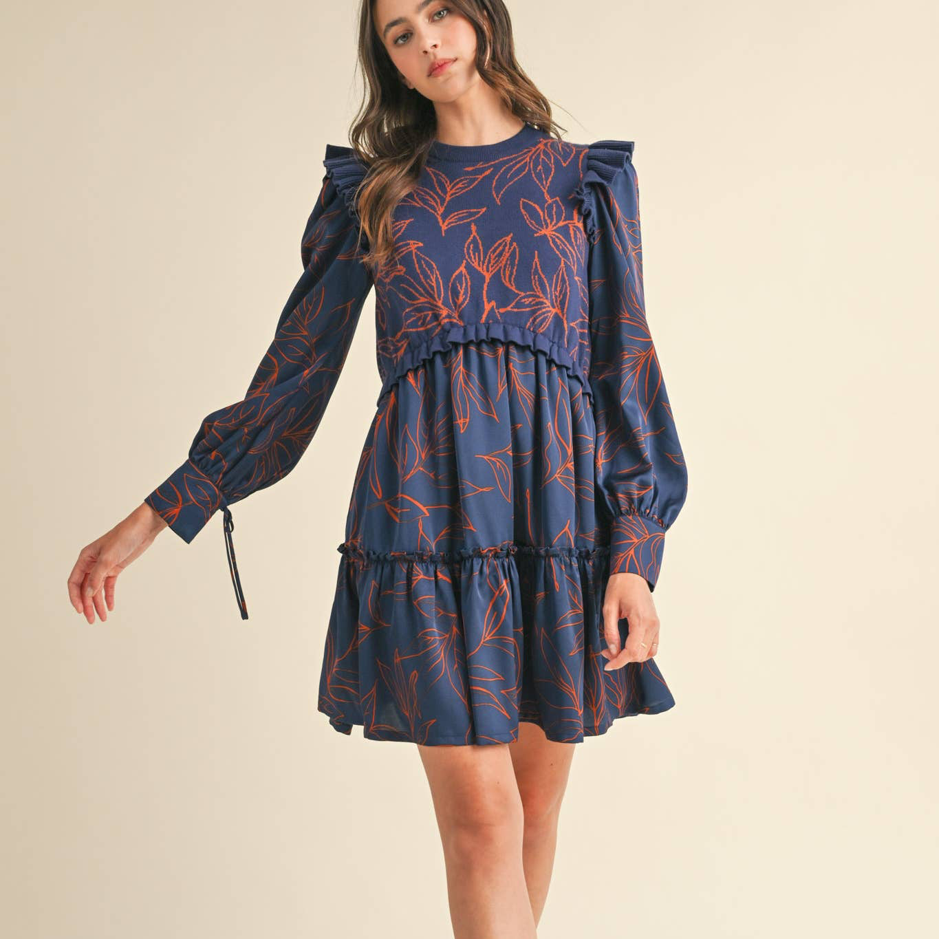 *&merci exclusive print!* Make your fall style dreams come true with a pair of cute boots and this mixed media sweater dress! An &amp;merci exclusive leaf pattern adorns the cozy sweater knit bodice with a round neck, ruffled knit shoulders, and ruffle hem. Soft satin fabric shapes long puff sleeves with banded cuffs and tying closure detail. A twirly satin woven skirt bottom is finished off with a ruffle trim at the mini hem.