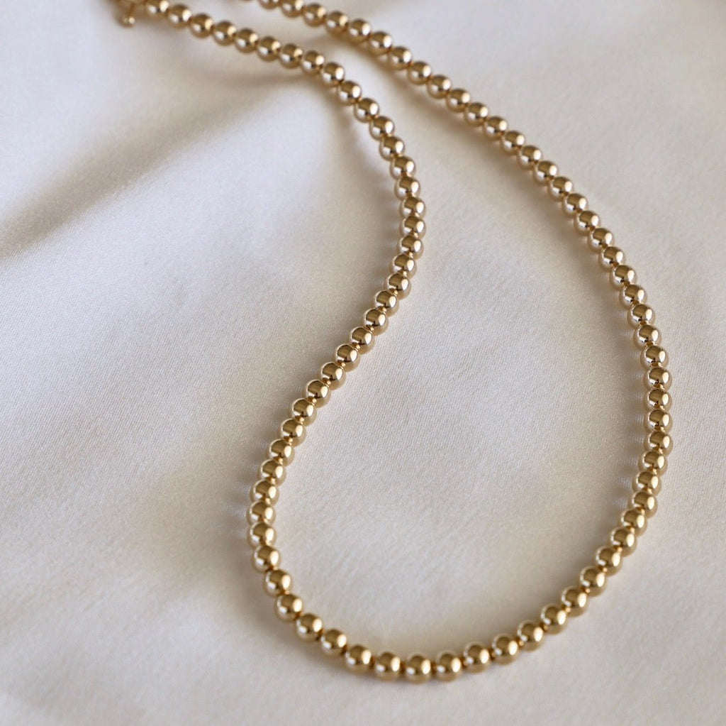 Sprinkle some sparkle into your wardrobe with our Gold Filled 5MM Beaded Necklace. This dazzling piece will add a touch of elegance to any outfit, perfect for both casual and formal occasions. Shine bright like a diamond with this must-have accessory!