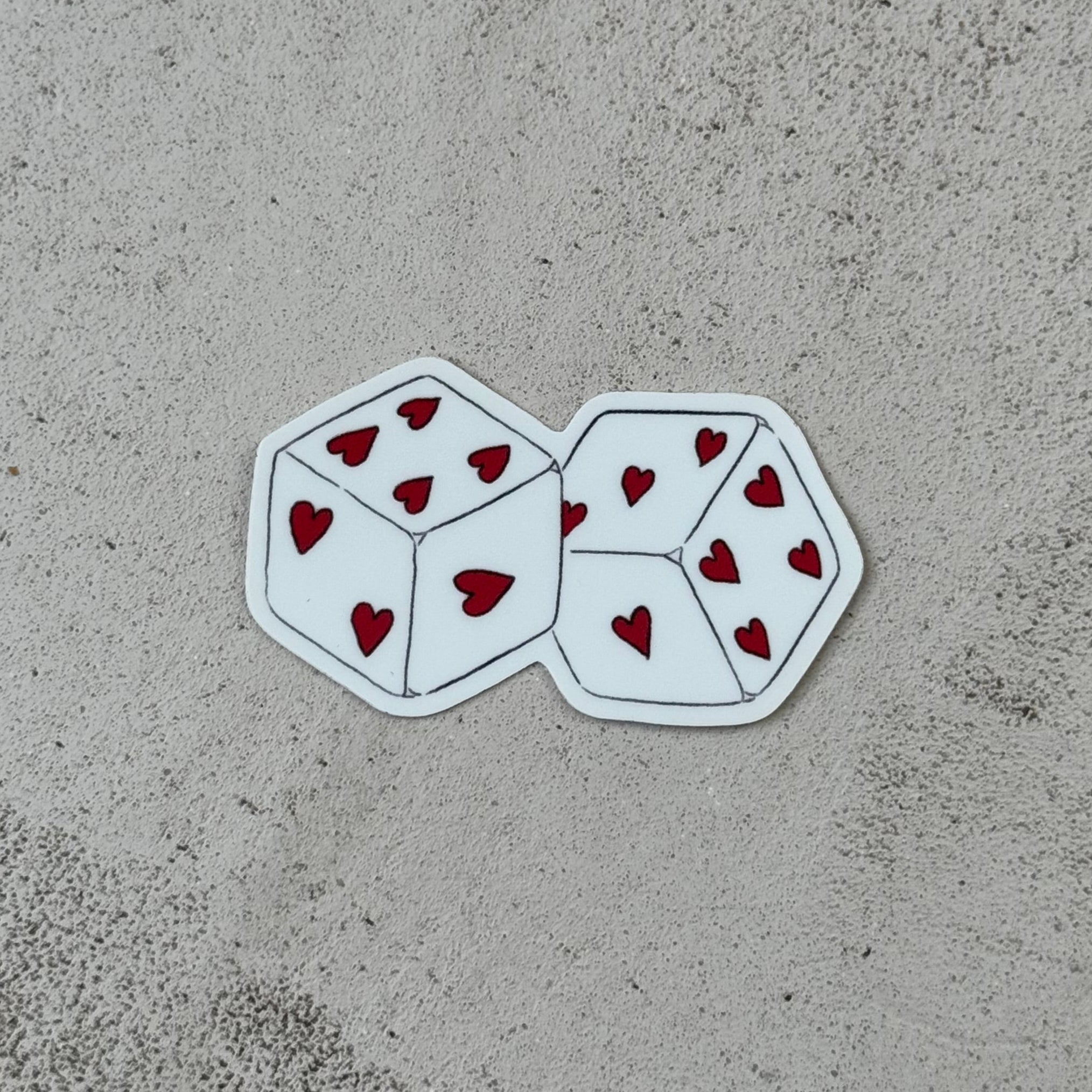 a pair of white die with hearts for dots
