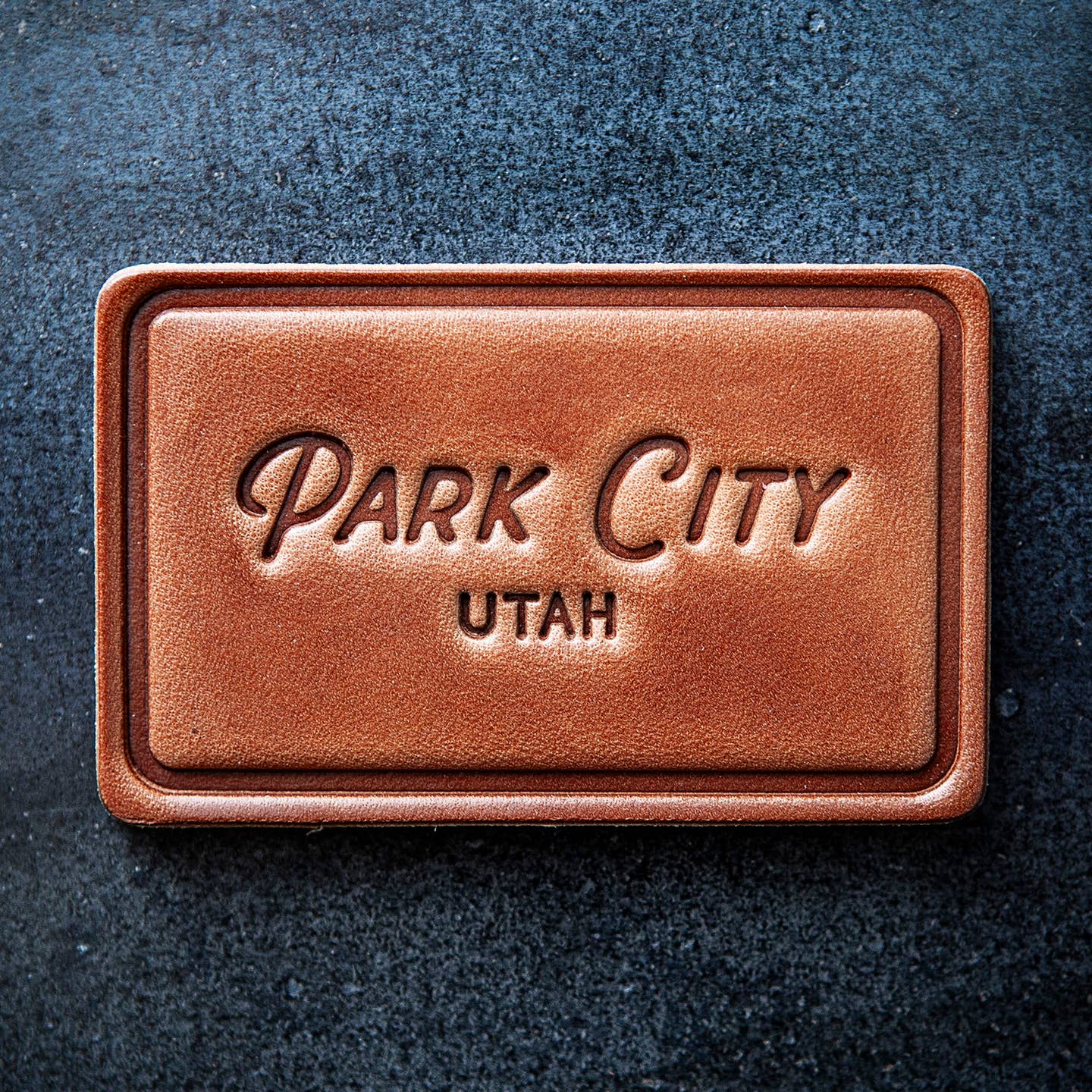 This leather magnet comes in a block style featuring “Park City, Utah” in beautiful calligraphy. Our leather magnets are cut and embossed from some of the thickest and finest harness leather available, and patina beautifully as they age.

Size: 2.8” x 1.75”