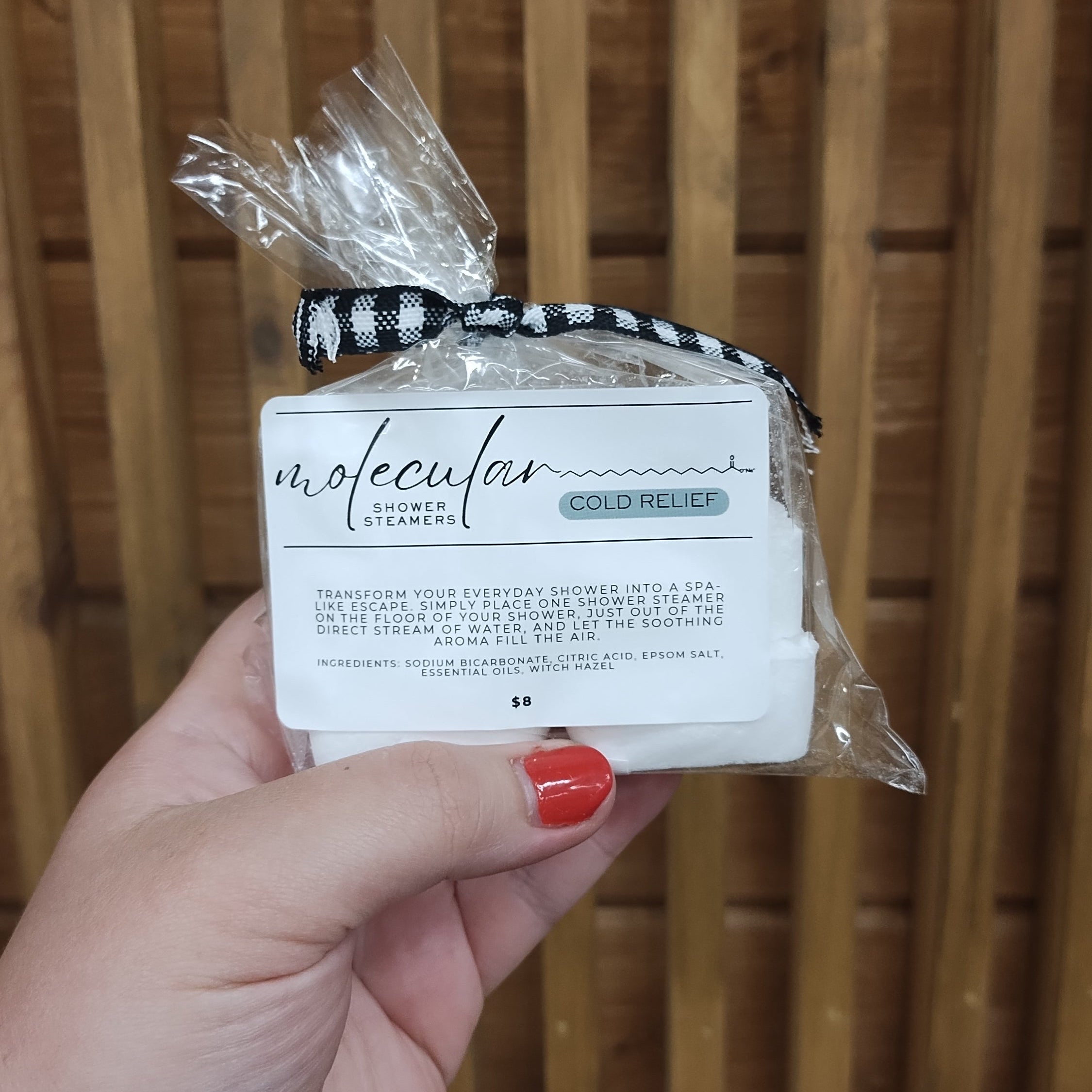 Cellophane bag with 6 square white shower steamers. Tied with a black gingham bow, has a white minimalistic label.