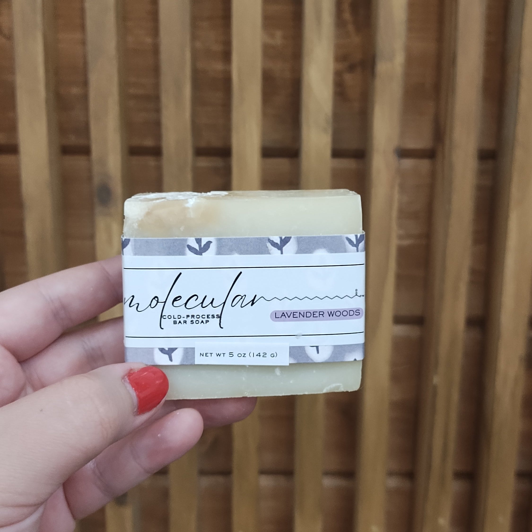 Roughly cut white bar soap with a purple floral label. 