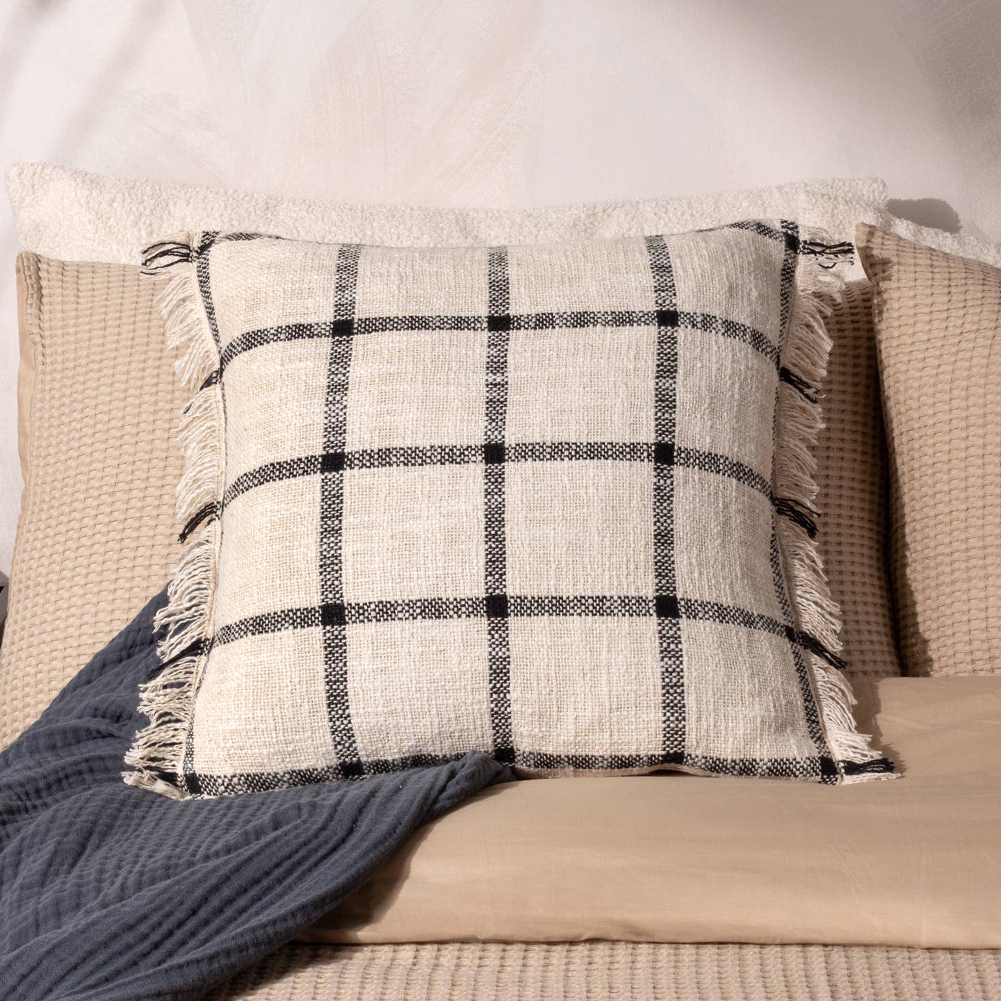 The Beni cushion is made for those who love to combine modern classics with relaxed living. Featuring an adorned contrast check weave. This design is set on a soft slub cotton base and is finished with a double-sided fringed trim. Available in natural and earthy tones, this cushion will layer perfectly within any interior.
