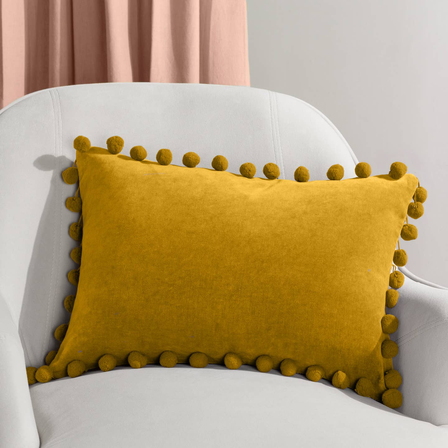Sometimes it's the simple things that creates the perfect cushion. Take a soft, plain cotton velvet face and add multiple pom-poms around the edge in a range of spring tones and you have the perfect addition to your home decor. This cushion will add character and a pop of colour to most interiors. Featuring a plain cotton velvet face with a pom-pom trim. Complete with a plain cotton reverse and hidden zip fastening.