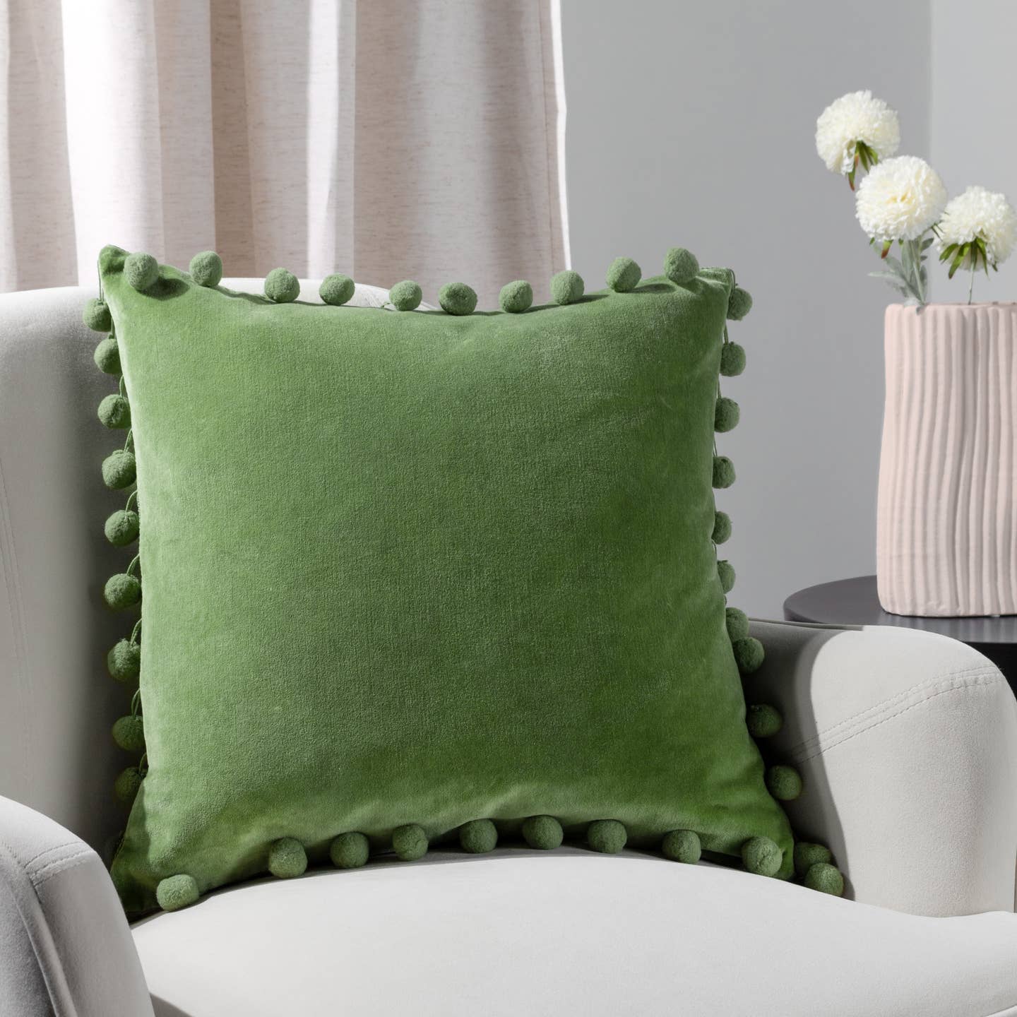 Sometimes it's the simple things that creates the perfect cushion. Take a soft, plain cotton velvet face and add multiple pom-poms around the edge—you’ll have the perfect addition to your home decor. This cushion will add character and a pop of colour to most interiors.