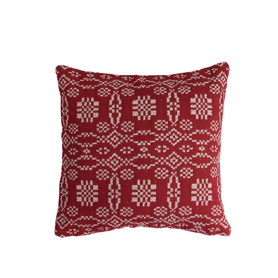 Red pillow with white geometric pattern on a white background