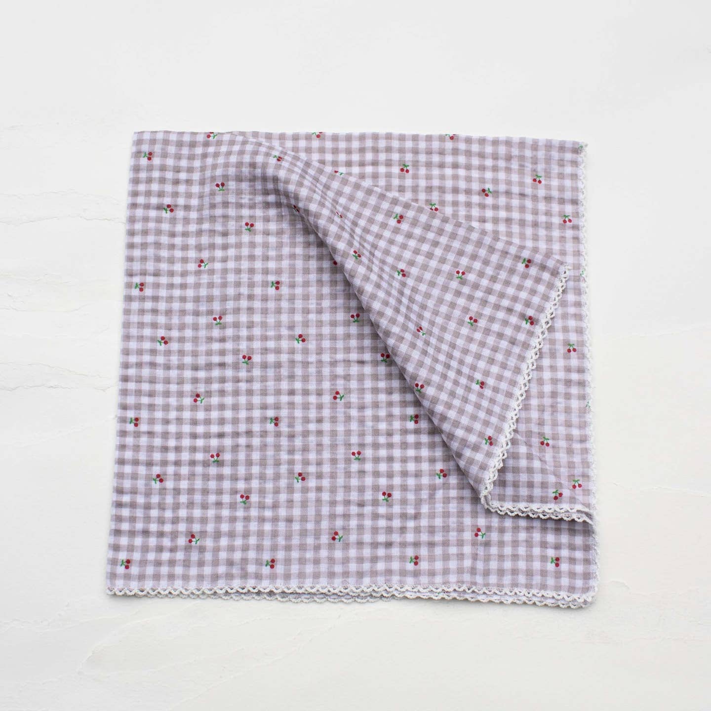 This Cottage Mini Checker scarf features delicate tiny cherry patterns woven into a soft blend of cotton and rayon, offering lightweight comfort and breathability. Its classic khaki-inspired color adds a versatile touch to any outfit, perfect for adding a subtle pop of charm while keeping you cozy throughout the day.