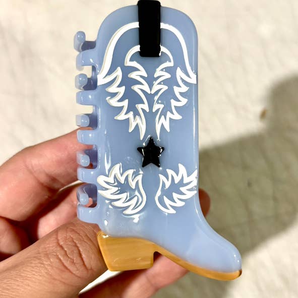 Western Boot Hair Claw Clip, the perfect accessory for any Western-inspired outfit. Made with sustainable materials, this clip showcases an intricate boot design and features a secure, easy-to-use grip. Upgrade your hair game with this eco-friendly and stylish clip.