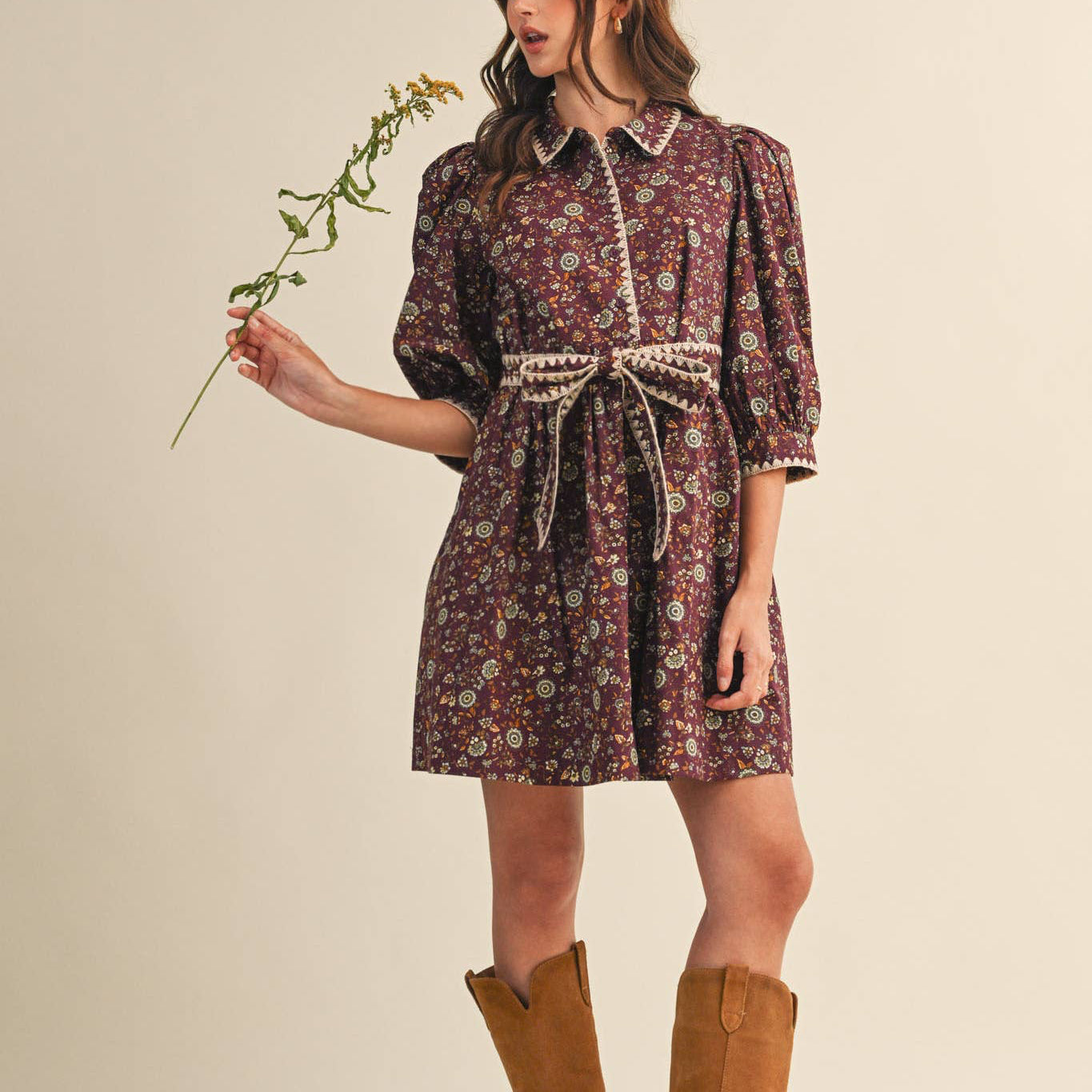 This plum-colored mini dress features charming puff sleeves and a delicate floral pattern, offering a flattering silhouette that blends comfort with playful elegance. Perfect for warm days or layered looks, it adds a touch of feminine flair to your wardrobe with its soft fabric and thoughtful design.
