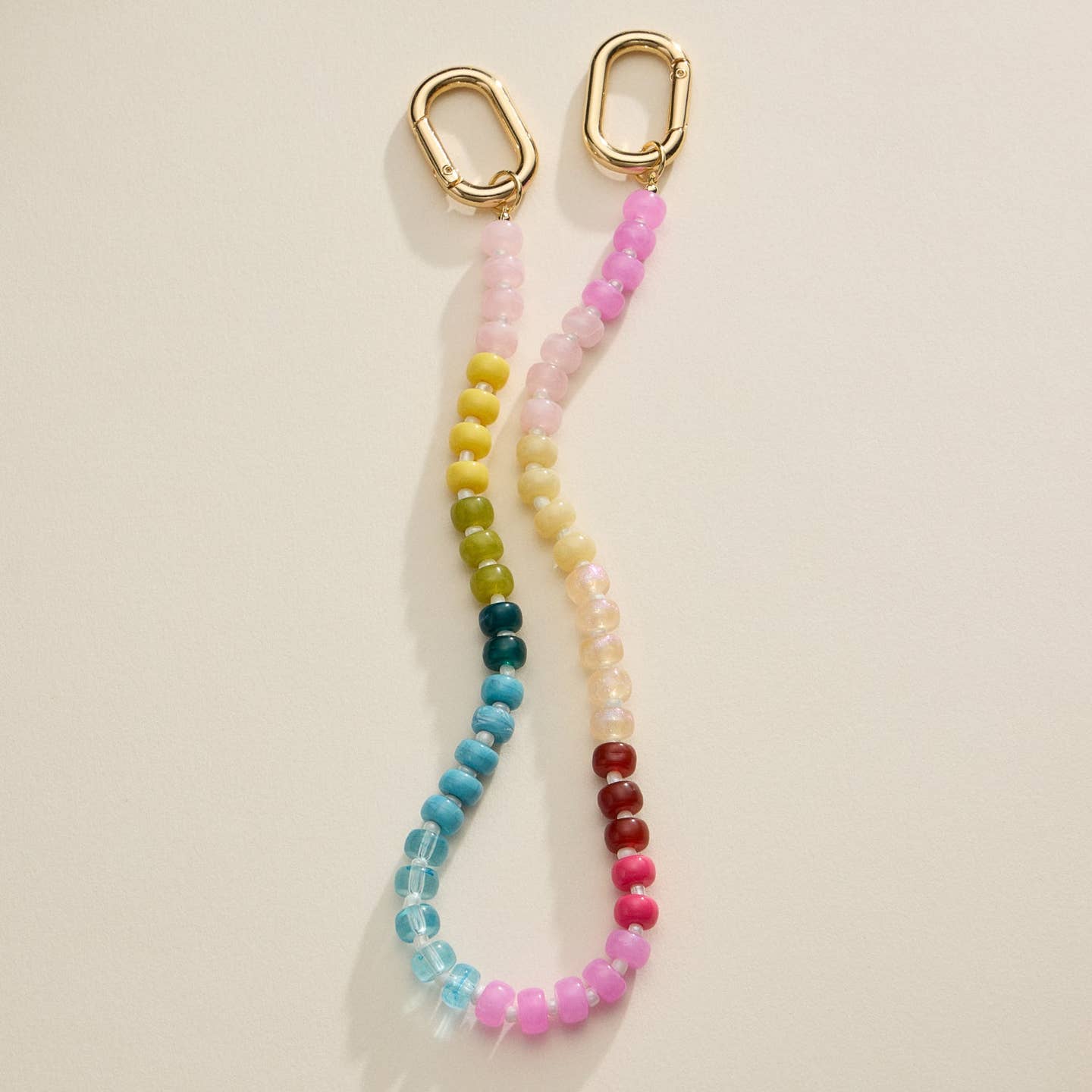 Add a pop of color to your bag with this vibrant beaded bag charm featuring a gold clasp. A stylish and fun accessory perfect for customizing your handbag or keys.