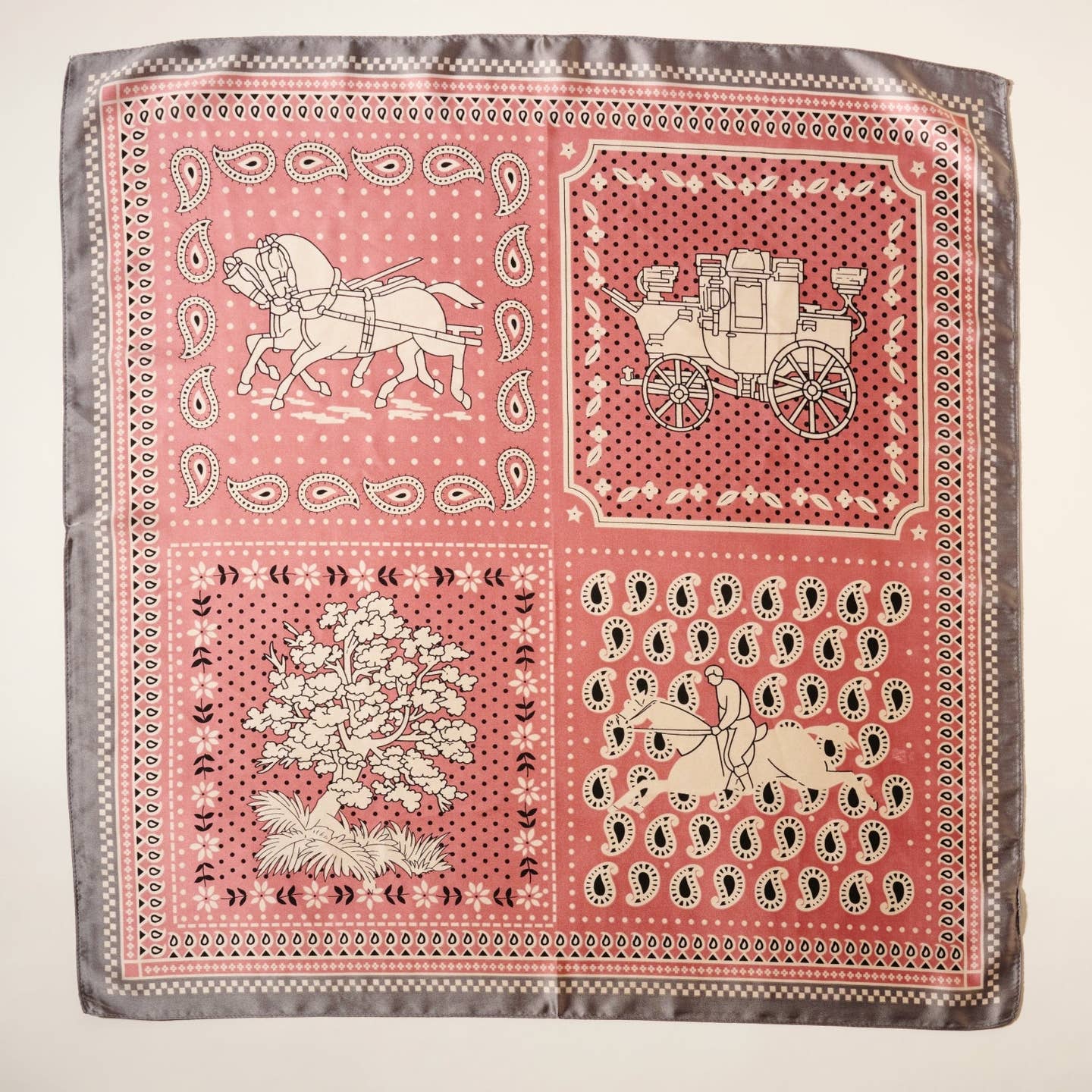 Embrace classic Western charm with this silk-feel polyester scarf, featuring a beautifully detailed horse and carriage print accented by paisley and floral motifs. Designed with a vintage-inspired bandana aesthetic, this scarf blends rustic elegance with a modern touch. The lightweight, silky-smooth polyester offers the luxurious feel of silk while being durable and easy to maintain.

Available in soft dusty pink with gray accents, this scarf is the perfect statement piece for Western-chic fashion lovers.