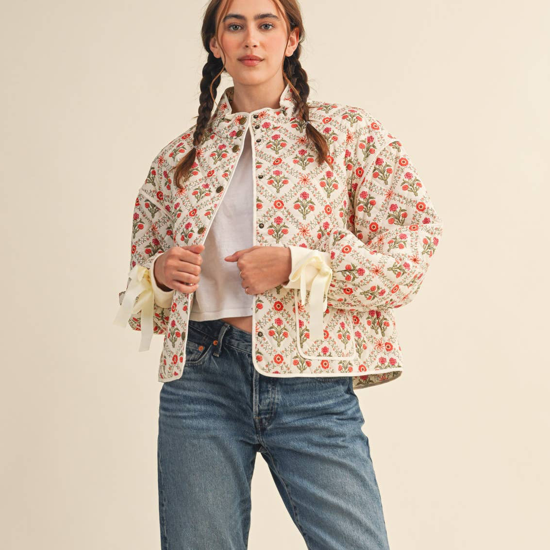 Be the trendsetter that you are in this floral quilted jacket! Quilted puffer shapes this chic jacket that features delicate and lovely floral print throughout and has a stand collar, a button down closure, and drop shoulder long balloon sleeves. A gorgeous ribbon detail ties at the cuffs for an extra romantic look. Contrast binding lines the edges and pockets of this jacket.
