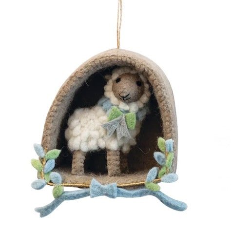Decorative ornament with a sheep in a hut on a white background