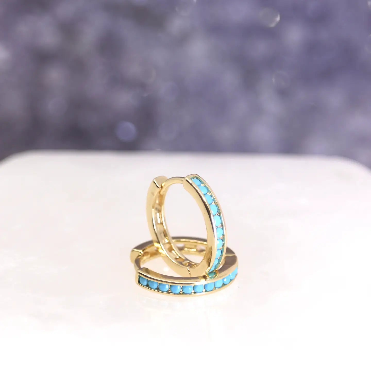 These turquoise hoops are named after Calypso, a well-known nymph in Greek mythology thanks to her role in the legend of Odysseus. She was known to be a goddess of strange power and beauty.