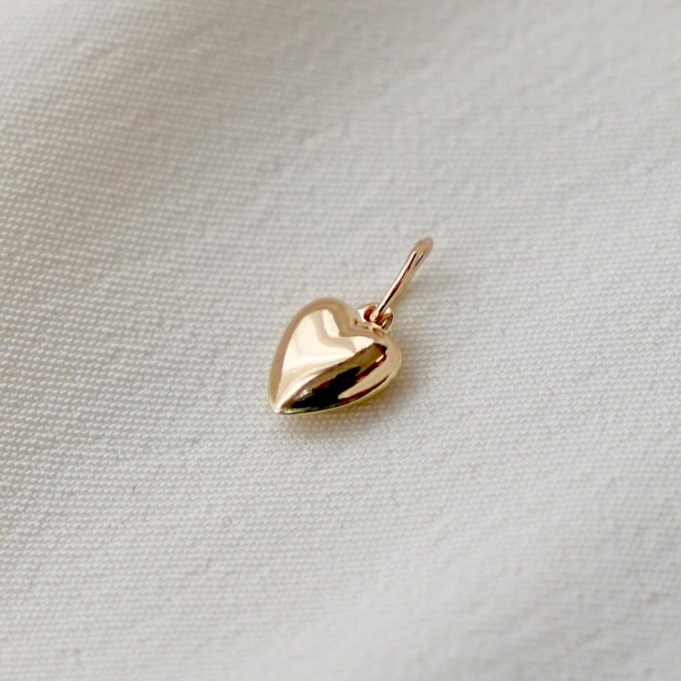 This gold filled or sterling silver mini heart charm is an elegant addition to any jewelry collection. The high-quality material ensures durability and adds a touch of sweetness to any piece. With its timeless design, it makes for a perfect gift for a loved one or a special treat for yourself.