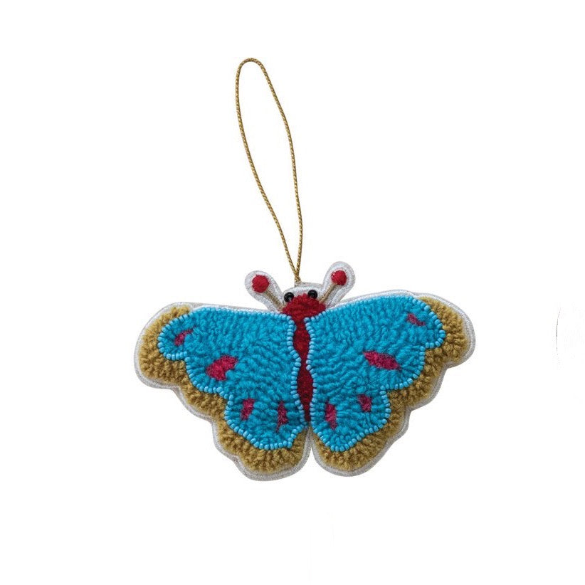 Embroidered butterfly ornament with blue wings and red accents on a white background