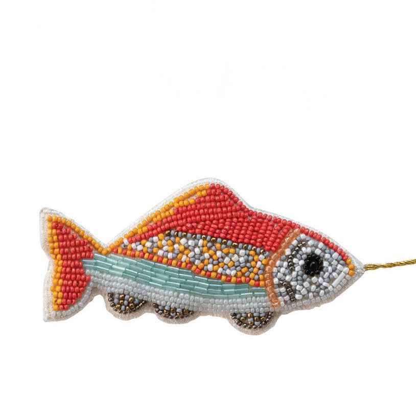Beaded fish-shaped ornament on a white background