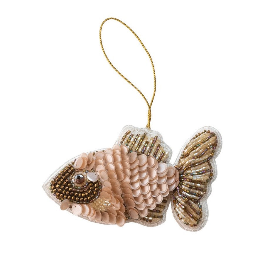 Decorative fish ornament with bead details on a white background