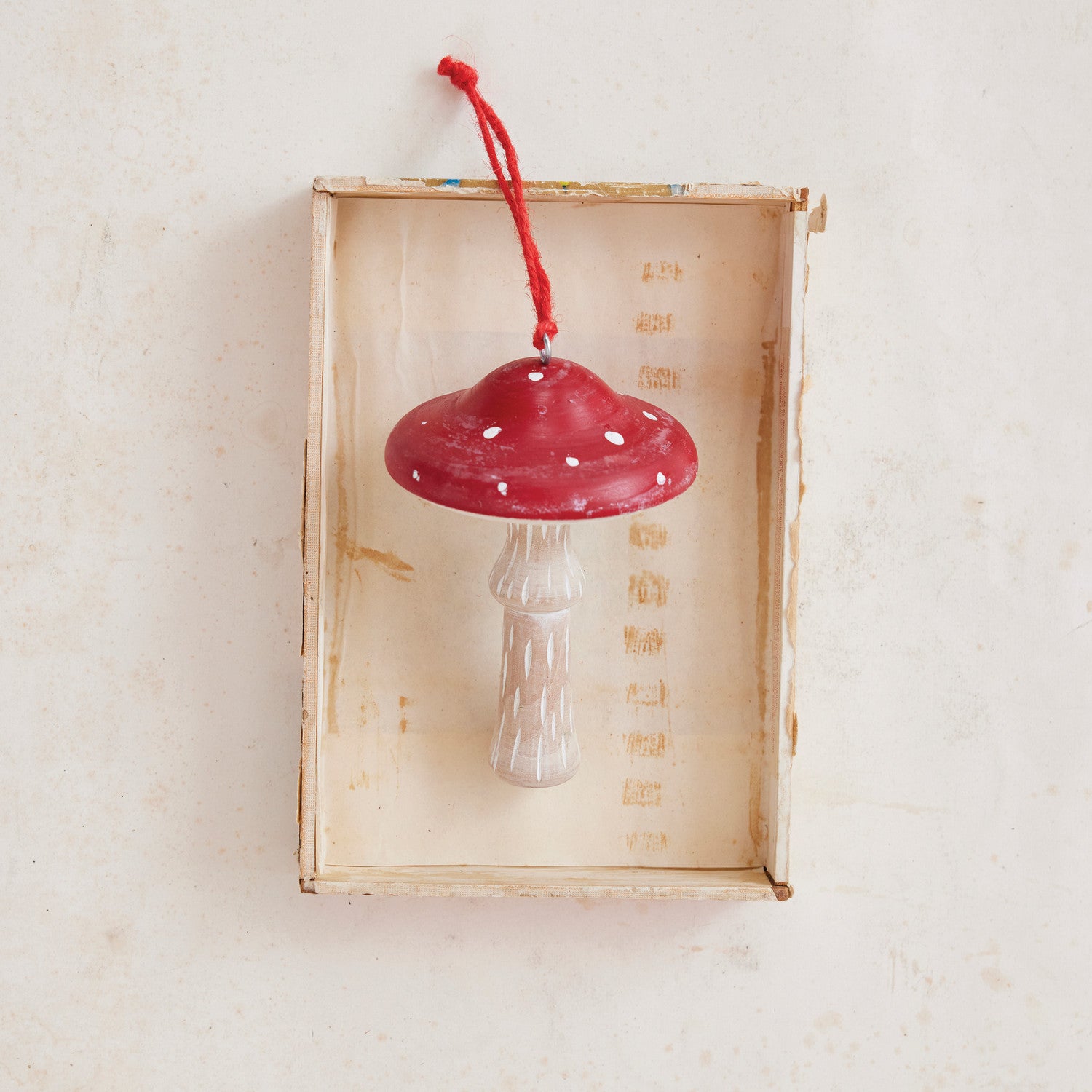 This charming whitewashed wood mushroom ornament features a vibrant red top, adding a playful touch to any space. Crafted with care, it brings a subtle natural accent that complements various decor styles, perfect for brightening shelves, tabletops, or seasonal displays. Its handcrafted appeal makes it a delightful addition for those who appreciate rustic, whimsical decor.