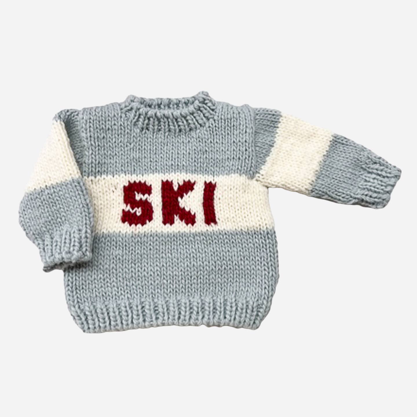 Ski season wouldn't be complete with this skit sweater, hat and mittens set. Get your little one ready for ski season in this Bowie Grey, Cream, and Red set. Available in other colors.

Details:

Designed in Salt Lake City
Crafted with care using 100% Hand-knit Acrylic
Hand wash and lay flat to dry