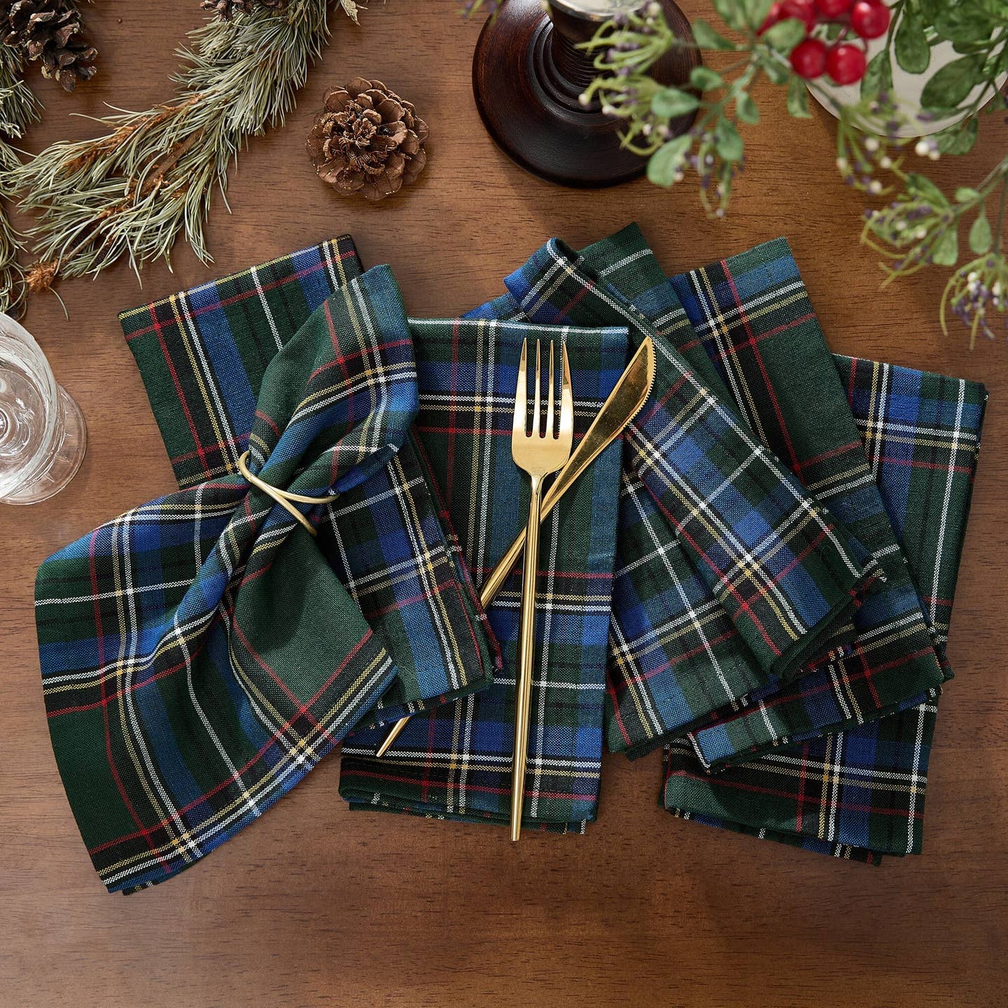 Elevate your holiday gatherings with our exquisite Stowe Tartan Plaid Napkin Set. Versatile and elegant, this set of reusable napkins displays a yarn-dyed pattern and is available in a festive color palette featuring shades of Christmas red, hunter green, royal blue, gold and white to compliment a variety of seasonal dinnerware. Woven using premium quality 100% cotton, these lap napkins feature a hemmed edge for added protection. Set of 4.