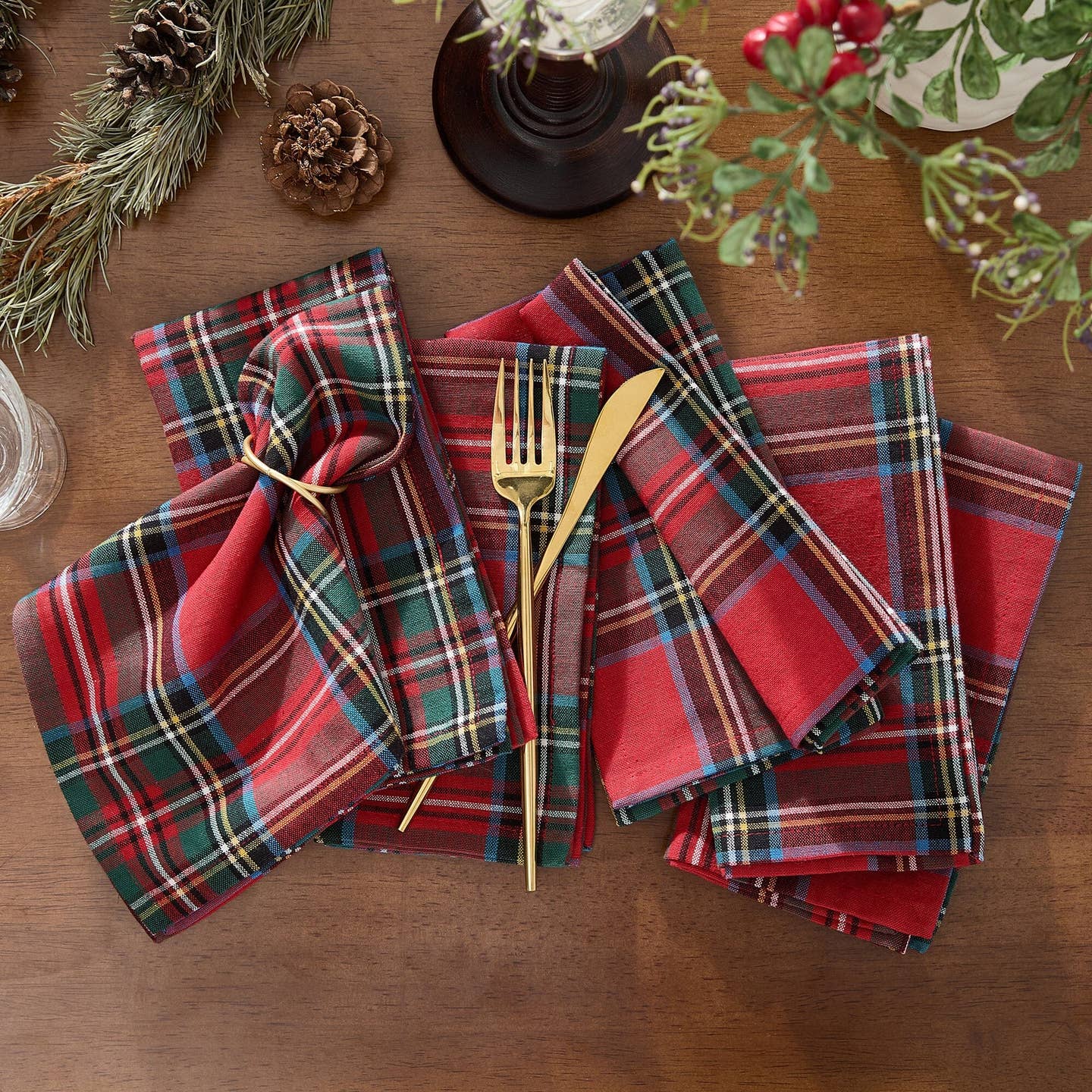 Elevate your holiday gatherings with our exquisite Stowe Tartan Plaid Napkin Set. Versatile and elegant, this set of reusable napkins displays a yarn-dyed pattern and is available in a festive color palette featuring shades of Christmas red, hunter green, royal blue, gold and white to compliment a variety of seasonal dinnerware. Woven using premium quality 100% cotton, these lap napkins feature a hemmed edge for added protection. Set of 4