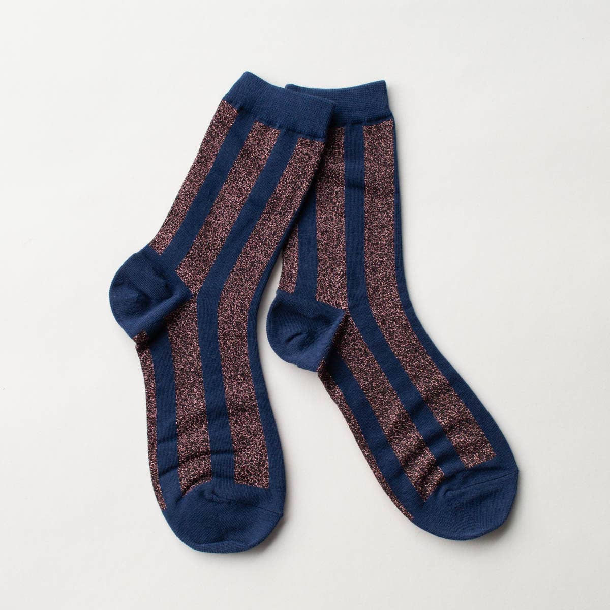 Make a statement with these striking crew socks showcasing bold vertical stripes in navy and mauve, enhanced with eye-catching glitter accents. Designed to bring sparkle to your everyday wardrobe, these socks combine playful style with dependable comfort. The crew-length cut provides excellent support and coverage for all-day wear, whether you're heading to the office, out on adventures, or simply relaxing at home. Slip them on and let your feet do the talking with this fun, versatile essential.