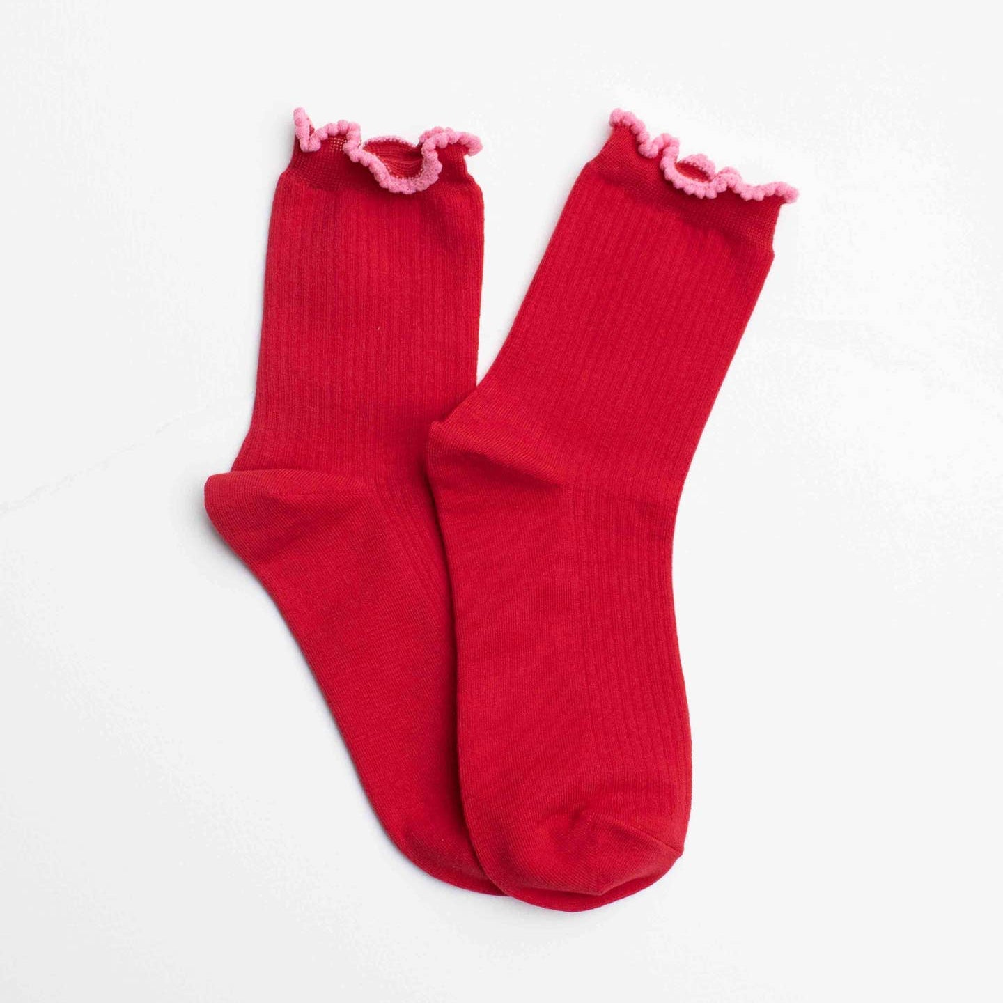 Celebrate the season in style with these festive crew socks that blend holiday charm with everyday comfort. The rich classic red pairs beautifully with a soft pink ruffle edge, creating a look that's both cheerful and sophisticated. Whether you're wrapping gifts, gathering with loved ones, or simply spreading seasonal joy, these socks add a warm, thoughtful touch to your holiday wardrobe. Perfect for gifting or keeping for yourself, they're a cozy way to embrace the spirit of the season.

Adult Size