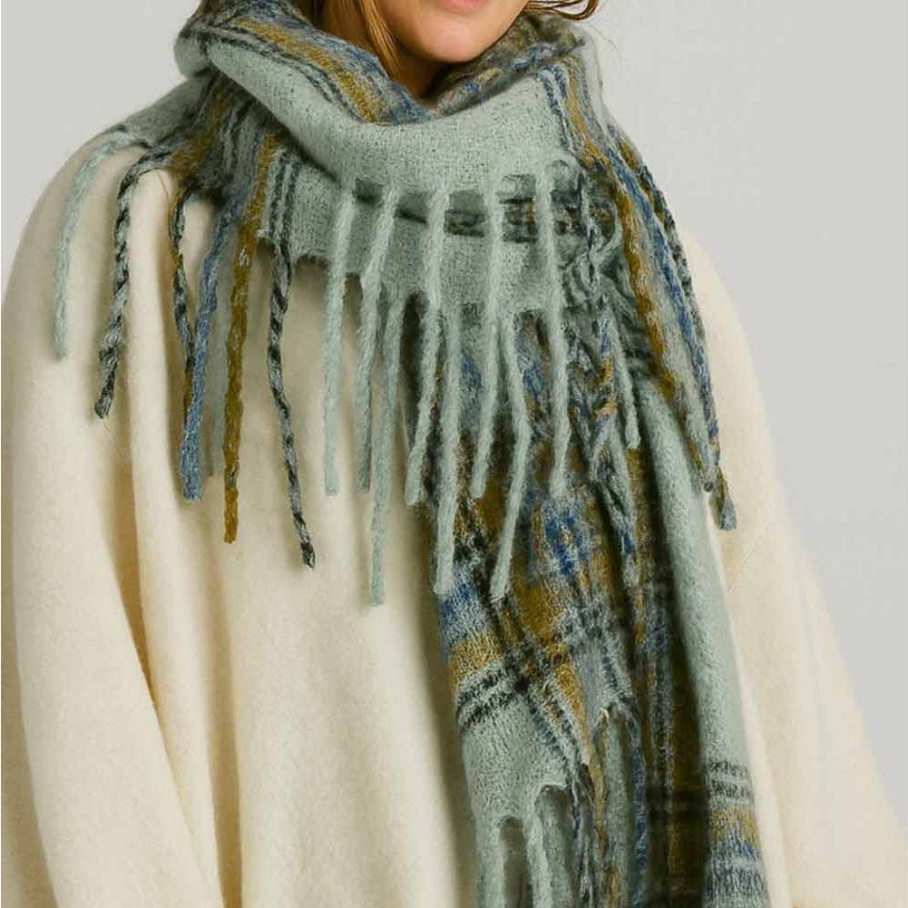 Wrap yourself in warmth and style with this mint plaid knit scarf. Crafted from soft, cozy yarn with a classic plaid pattern, it's the perfect layering piece for cooler days. The fringed ends add a charming, finished touch that elevates any outfit. Whether you're heading out for a casual stroll or dressing up your everyday look, this versatile scarf brings both comfort and character to your wardrobe.

Details:

100% Polyester
Casual, light fitting scarf
Size: 40*185cm