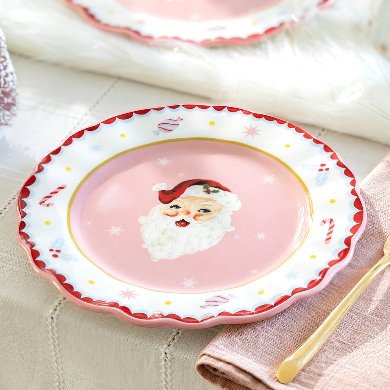 Bring festive cheer to your holiday table with this delightful Pink Santa Dessert Plate. Featuring a whimsical Santa face design, this charming plate adds a playful touch to dessert service and holiday gatherings. Perfect for serving treats during Christmas celebrations, it combines cheerful aesthetics with practical functionality. The soft pink hue creates a warm, inviting presentation that complements both traditional and modern table settings. 8.5” diameter.