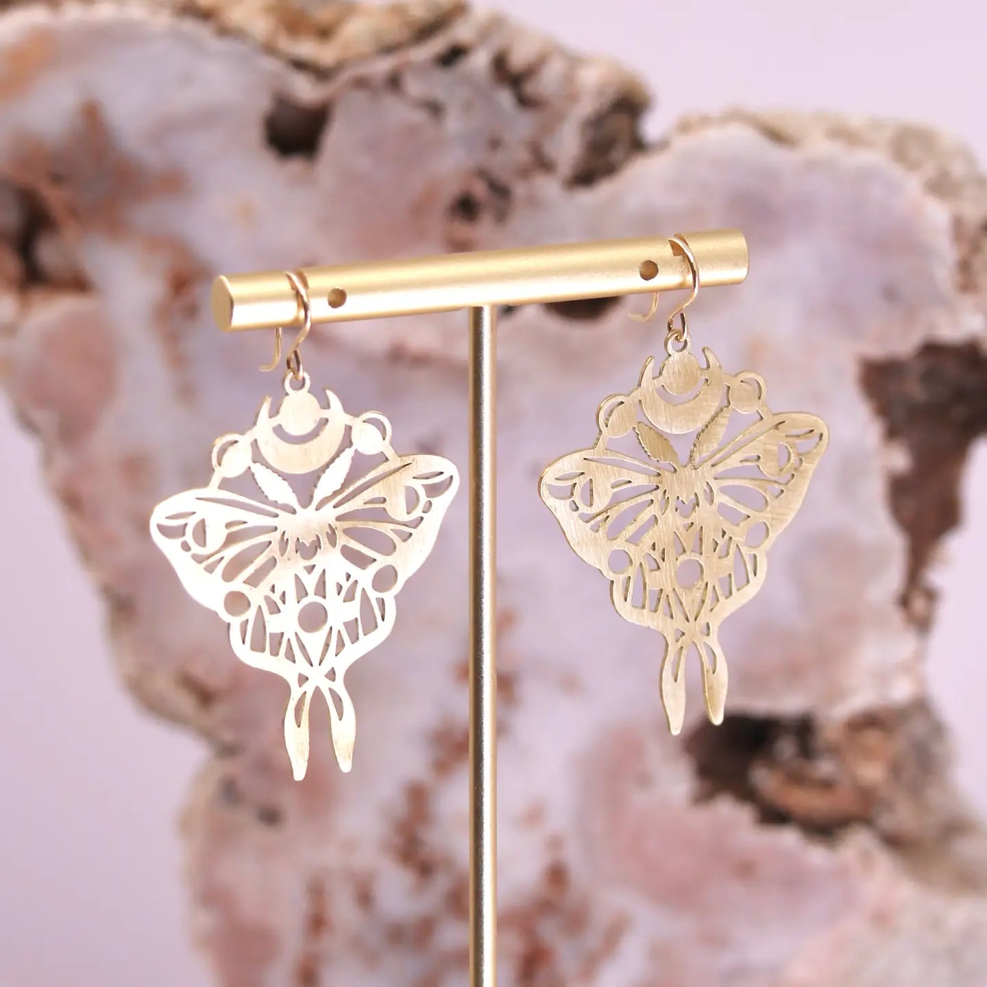 Meet your new favorite earrings—a whimsical pair featuring a beautifully laser-cut moth crowned with a dreamy moon phase halo. Crafted in brass and designed to be feather-light, these statement pieces blend nocturnal charm with wearable comfort. Perfect for anyone who loves a touch of celestial magic in their everyday style.

Details:
laser-cut brass charms
goldfill earring hooks
35mm x 45mm