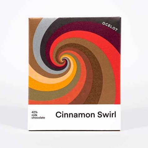 Silky 42% Esmeraldas milk chocolate blended with crisp buttery cinnamon bun, freshly baked by Wild Hearth Bakery in Perthshire.

Our organic 42% milk chocolate is made with rare Arriba beans from the Esmeraldas coast in Ecuador. Its rich caramel notes complete this delicious and comforting chocolate &amp; pastry experience.