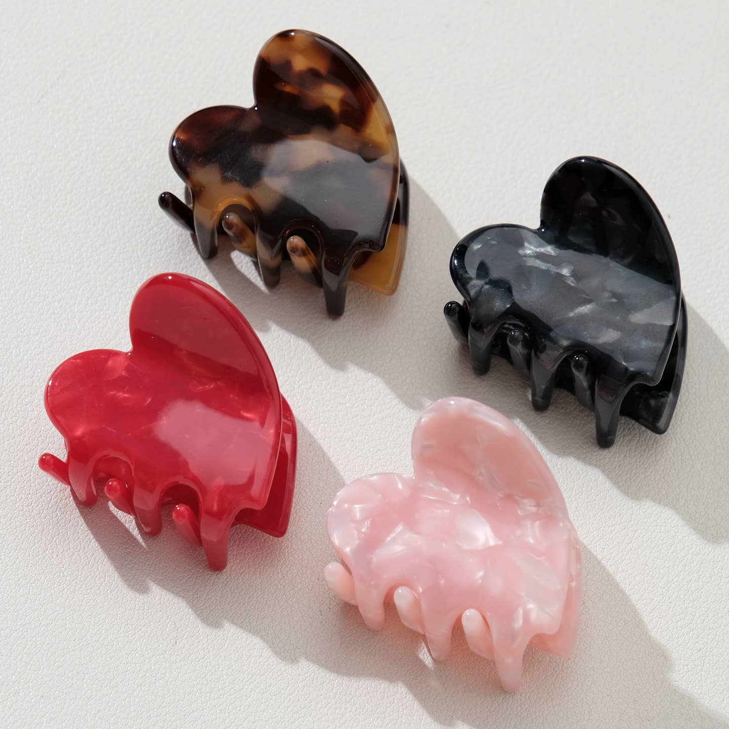 Adorable and functional, this mini heart claw clip brings a pop of cherry red charm to any hairstyle. Perfect for securing small sections of hair or adding a sweet accent to your look, this petite clip combines playful design with reliable hold. Whether you're styling for everyday wear or special occasions, this heart-shaped accessory is a delightful way to express your personal style while keeping hair in place.

Details:

Small (1.7 inch)
Materials: Cellulose Acetate