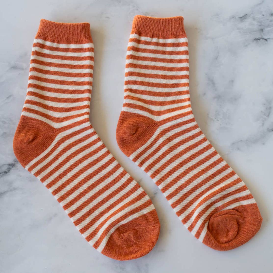 Step into understated elegance with these rust-colored crew socks, designed with delicate thin stripes that add visual interest without overwhelming your look. Lightweight and breathable, they're ideal for everyday wear in any season. Whether you're dressing up or keeping it casual, these socks provide the comfort and support your feet need throughout the day. A versatile staple that pairs beautifully with any outfit in your wardrobe.