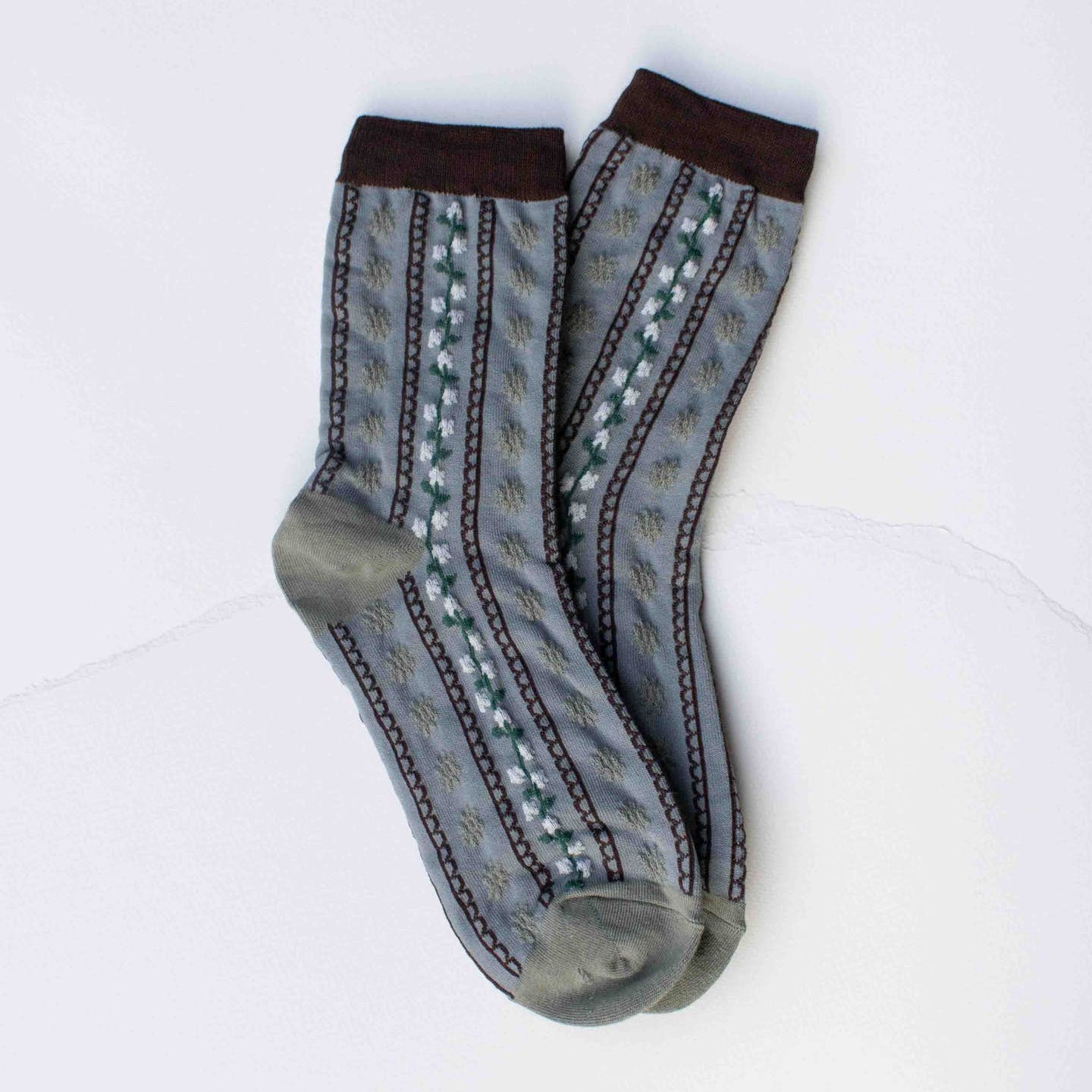 Step into comfort with these charming vintage-inspired crew socks featuring delicate floral stripes in soothing grey and warm wood tones. Perfect for adding a touch of nostalgic style to your everyday wardrobe, these casual socks blend timeless design with modern comfort. Whether you're relaxing at home or out and about, they're the ideal choice for anyone who appreciates classic patterns with a cozy, laid-back vibe.