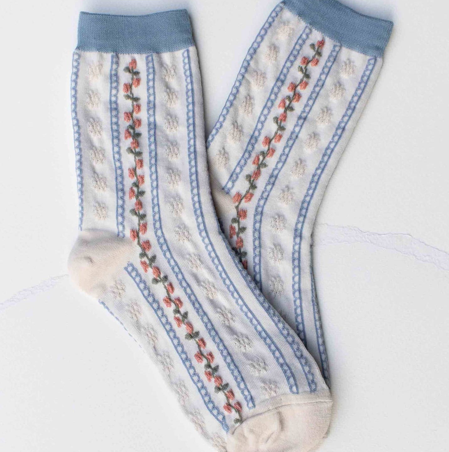 Step into comfort with these charming vintage-inspired crew socks featuring delicate floral stripes in soothing ivory and blue tones. Perfect for adding a touch of nostalgic style to your everyday wardrobe, these casual socks blend timeless design with modern comfort. Whether you're relaxing at home or out and about, they're the ideal choice for anyone who appreciates classic patterns with a cozy, laid-back vibe.