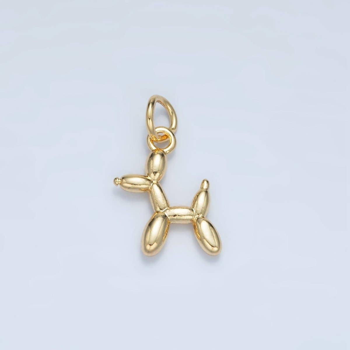 Whimsical balloon dog charm crafted in brass with a 24K gold-filled finish. This playful miniature measures 14.6mm x 11mm x 2.7mm, perfect for adding character to bracelets, necklaces, or jewelry projects. Lead-free and nickel-free for sensitive skin. A delightful accent piece from Salt & Honey Charmed.