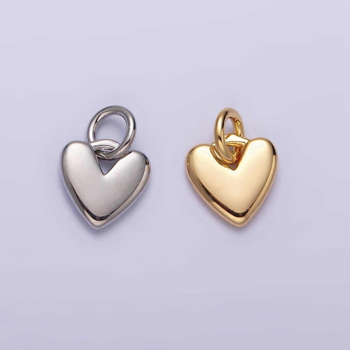 A timeless essential for any jewelry lover, our Mini Heart Charm is the ultimate symbol of love and connection. Designed with a dainty, minimalist silhouette, this sweet addition brings a touch of romance to any curated look.