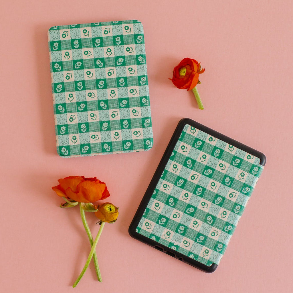 Checkers meet your floral era. Soft green edition. Designed by the talented Samantha Johnson

Really Fun Features (we promise):
• Faux leather exterior for easy cleaning
•&nbsp;Microfiber interior (cozy!)
• An elastic hand strap for comfortable holding
•&nbsp;Auto wake &amp; sleep feature to preserve battery life
• Shock absorption, TPU case for drop protection

Size: Paperwhite 12th Generation/Colorsoft (2024/2026)