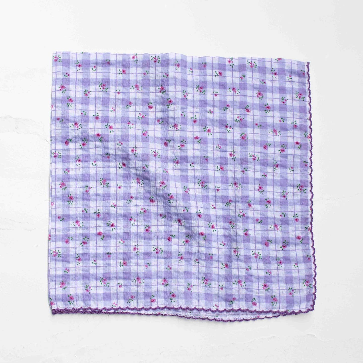 A delicate blend of vintage charm and everyday versatility, this square scarf features a soft plaid background accented with tiny floral prints. The lightweight cotton-rayon blend offers a breathable, silky feel with a gentle drape, making it perfect for year-round styling. Finished with subtle scalloped edges for an added feminine touch.

Wear it as a neck scarf, hair accessory, bag accent, or even as a petite wrap—an easy piece to elevate any look.
