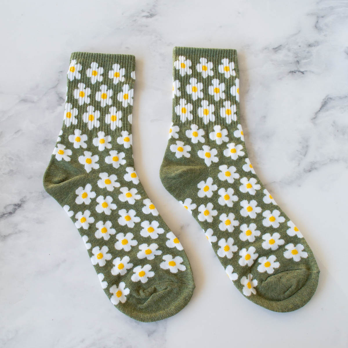 These Full of Daisy Socks bring a cheerful touch to your day with their warm rust color and charming white daisy pattern. Crafted for comfort and style, they offer a cozy fit that supports your feet throughout daily activities. Perfect for adding a subtle floral accent to any outfit while keeping you comfortable all day long.